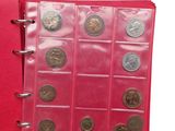 a red book with a bunch of coins inside of it