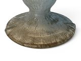 a glass vase that is sitting on top of a table