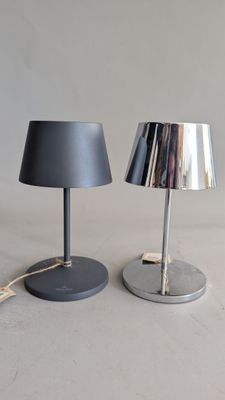 pair of black and silver table lamps on a white surface