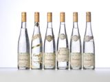 six bottles of wine are lined up in a row on a table