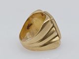 an image of a gold ring with a stone in the middle