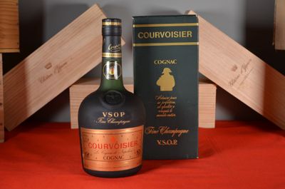 a bottle of courvoisier next to a box of wine