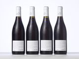 three bottles of wine are lined up on a table