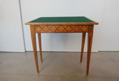 a small wooden table with a green top on it