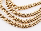 a close up of a gold chain necklace on a white background