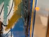 a picture of a man painting on a large piece of art