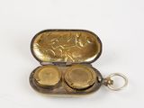 a small metal case with two coins inside of it