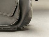 a black purse that is sitting on a table