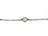 a silver bracelet with a heart charm on it