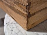 a wooden box sitting on top of a marble table