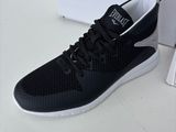 the black and white sneaker is next to a box of shoes