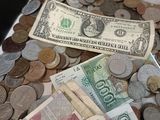 a pile of money sitting on top of a pile of coins