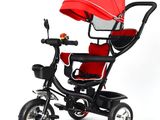 a small child ' s tricycle with a red canopy