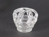 an image of a clear glass candle holder on a black background