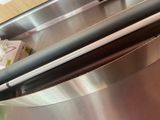 a close up of a stainless steel oven with a door open