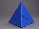 a close up of a blue triangular shaped object on a gray surface