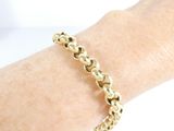 gold plated chain bracelet on a woman ' s arm