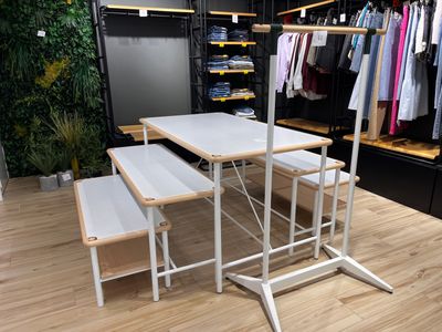une table blanche avec deux bancs devant