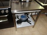 a small kitchen with a stove, sink, and stove top