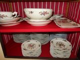 a red shelf with plates and bowls on it