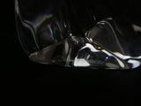 a close up of a glass of water on a black surface
