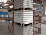 a large stack of metal boxes in a warehouse
