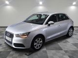 the silver audi is parked in a large room with a checkered floor