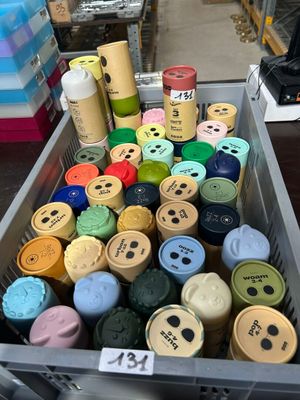 many different colors of paint in a container on the table