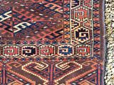 an old rug is laying on a gravel surface