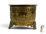 a gold planter that is sitting on a stand
