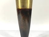a vase that is sitting on a white surface