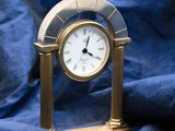 a gold clock sitting on a blue cloth