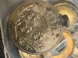 a coin in a bag with some coins inside of it