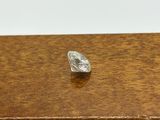 a close up of a diamond sitting on top of a wooden table