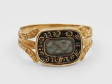 a close up of a gold ring with a stone in the center