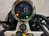 a close up of a motorcycle with a speedometer on it ' s handlebars