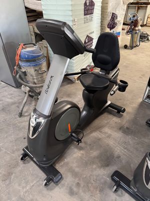 a stationary exercise bike in a garage with a water bottle
