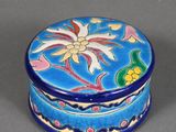 an image of a small blue box with a flower design on it