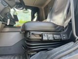 the interior of a vehicle with the door open and the seat up