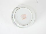 a white plate with a red stamp on it on a table