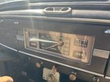 a close up of a car dashboard with a clock on it