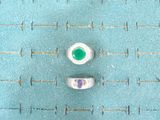 two pairs of white and green buttons on a blue surface