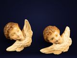 two figurines of angels on a blue background