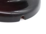 a close up of a black object on a white surface