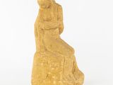 an image of a statue of a woman sitting on a rock