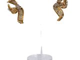 two pairs of gold and diamond earrings on a white surface