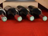 several bottles of wine are lined up in a row on a table