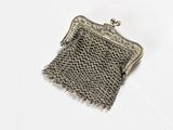 silver metal mesh purse on white background with clipping for clasp