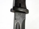 a close up of a knife on a white surface