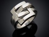 a close up of a silver ring on a black surface